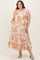 woman wearing a white and orange floral print maternity plus dress with a tiered skirt and a strapless design