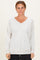 woman wearing a light gray v-neck long sleeve sweatshirt with a front pocket and relaxed fit