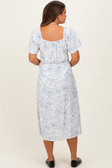 woman wearing a blue and white floral maternity dress with short sleeves and a square neckline