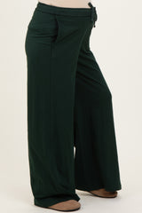 maternity wear in dark green wide-leg pants with a drawstring waist and side pockets