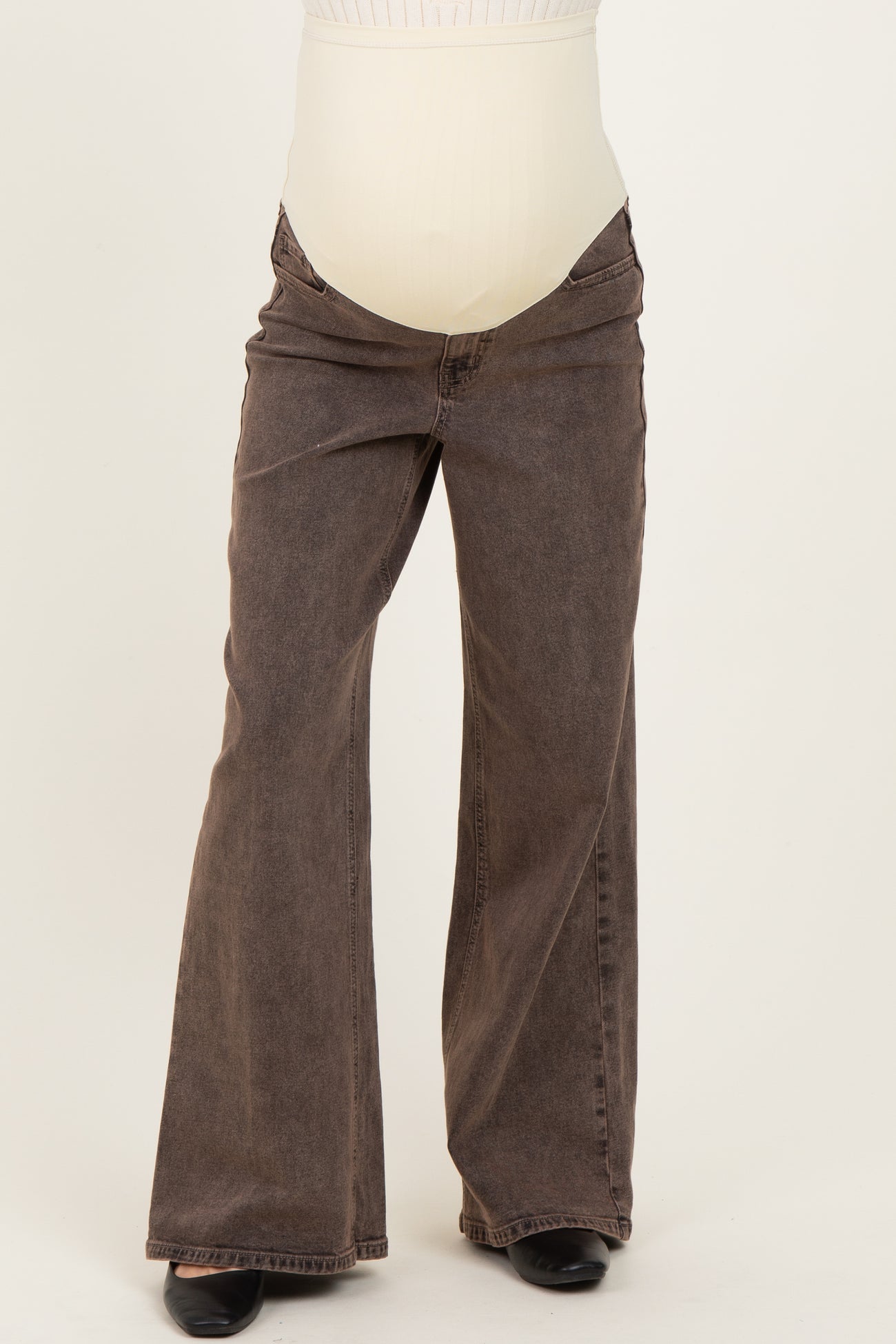 maternity wear brown bootcut jeans with a over-the-bump waistband, styled for comfort during pregnancy