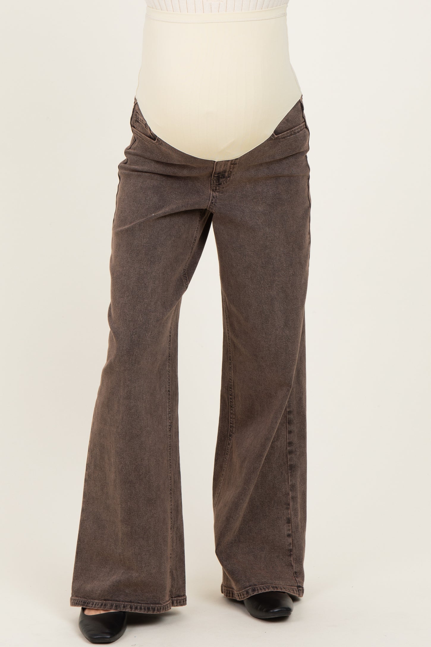 maternity wear brown bootcut jeans with a over-the-bump waistband, styled for comfort during pregnancy