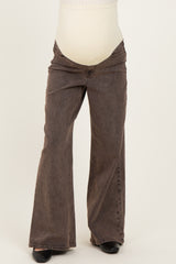 maternity wear brown bootcut jeans with a over-the-bump waistband, styled for comfort during pregnancy