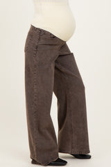 woman wearing a pair of brown wide-leg maternity jeans with a visible baby bump