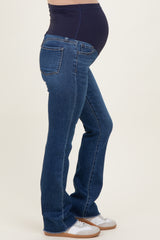 woman wearing dark blue maternity jeans with a stretchy panel and a visible baby bump