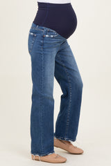 woman wearing a pair of blue maternity jeans with a dark blue panel and a visible baby bump