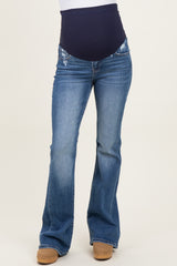 woman wearing blue maternity bootcut jeans with a navy blue panel and distressed detailing