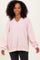 woman wearing a light pink ribbed oversized pullover sweater with a v-neck and balloon sleeves