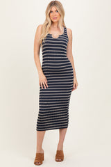 woman wearing a navy and white striped midi dress with a scoop neckline and fitted silhouette