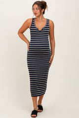 woman wearing a navy and white striped maternity maxi dress with a scoop neckline and form-fitting silhouette