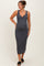 woman wearing a navy and white striped maternity maxi dress with a scoop neckline and form-fitting silhouette