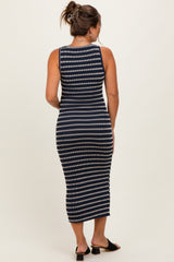 woman wearing a navy and white striped maternity dress with a fitted style and midi length, showing her back