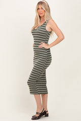 woman wearing a green and white striped casual midi dress with spaghetti straps and a fitted silhouette