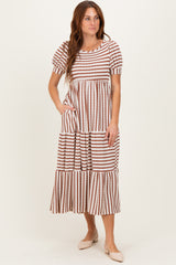 woman wearing a striped tiered midi dress with puff sleeves and pockets in neutral tones