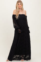 woman wearing a black off-the-shoulder lace maxi dress with long bell sleeves