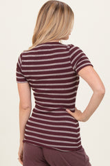 woman wearing a maroon and white striped short sleeve top seen from the back