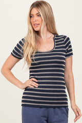 woman wearing a navy and cream striped short sleeve ribbed top with a scoop neckline