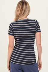 woman wearing a navy and white striped short sleeve top, viewed from the back