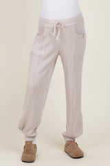 woman wearing beige ribbed maternity joggers with pockets and drawstring waist