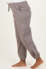 woman wearing gray maternity sweatpants with an elastic waistband and ankle cuffs