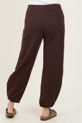 woman wearing brown sweatpants with elastic cuffs and back pockets, viewed from the back
