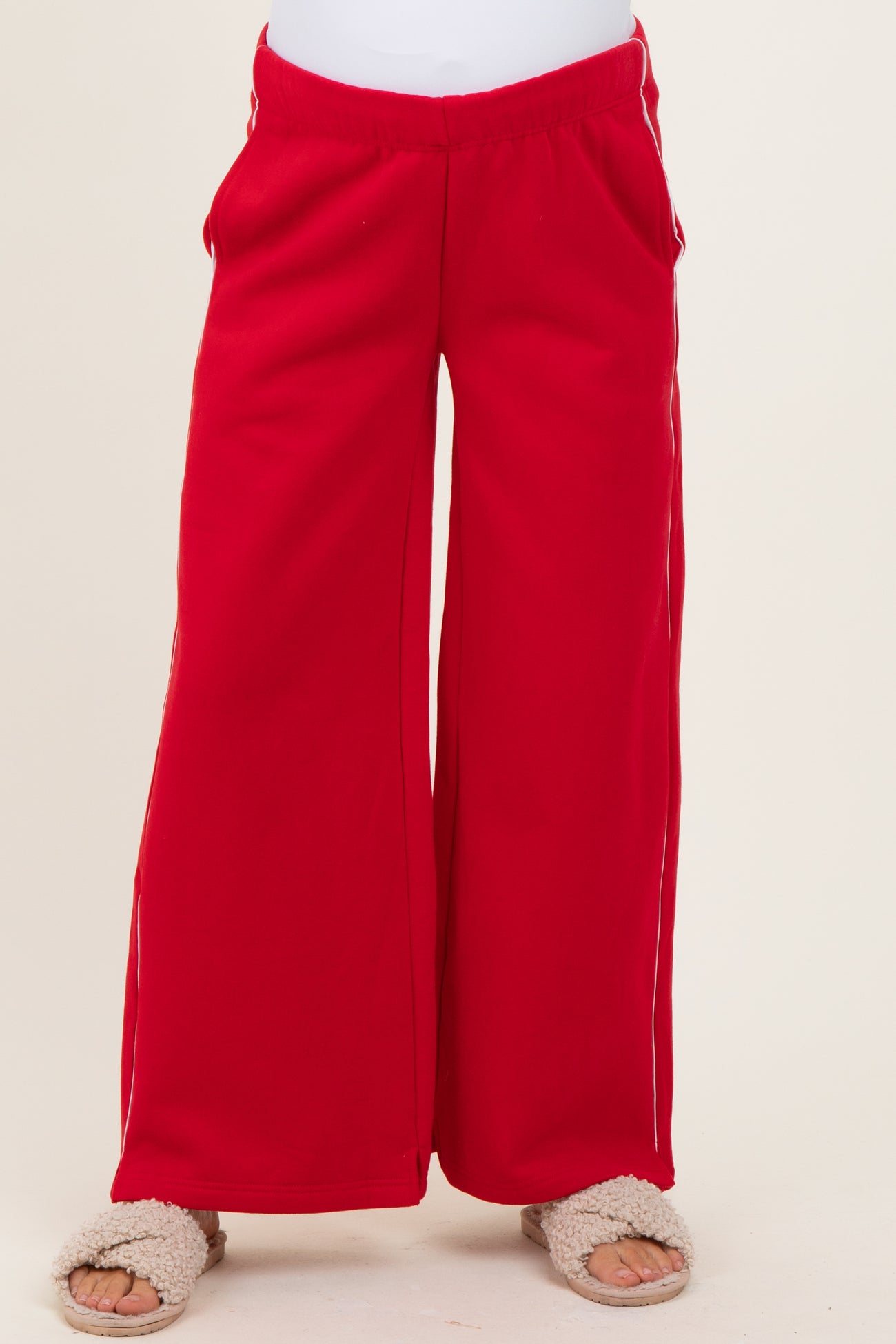 maternity wear red wide-leg sweatpants with side pockets, model wearing soft slippers