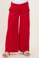 maternity wear red wide-leg sweatpants with side pockets, model wearing soft slippers