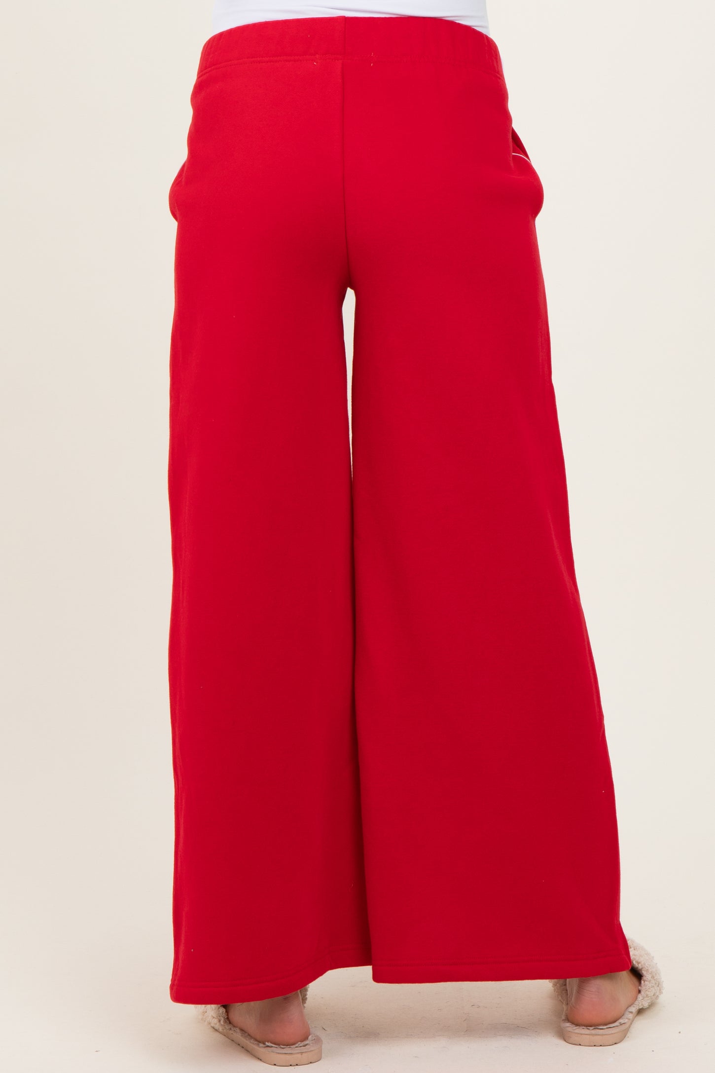 woman wearing red wide leg maternity pants, shown from the back