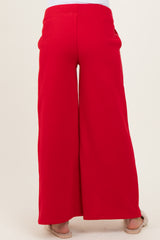 woman wearing red wide leg maternity pants, shown from the back