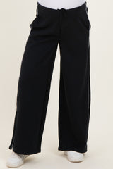 maternity wear in black wide-leg sweatpants with side pockets and elastic waistband, modeled by a pregnant woman