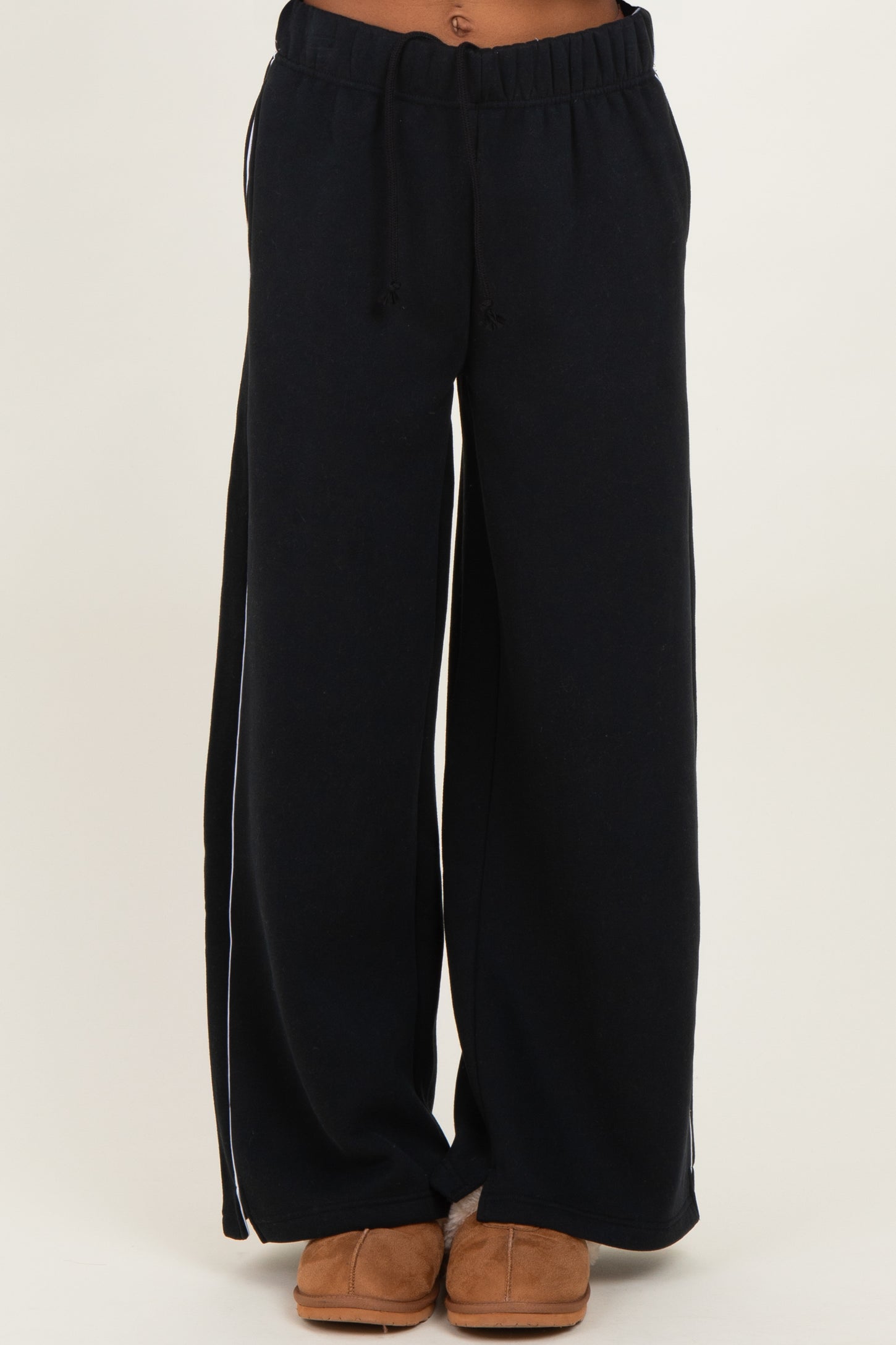 woman wearing navy blue wide-leg lounge pants with an elastic waistband and side pockets