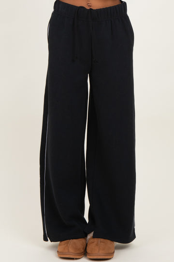 woman wearing navy blue wide-leg lounge pants with an elastic waistband and side pockets