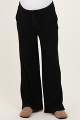 black maternity lounge pants with wide leg and drawstring waistband displayed on a white background