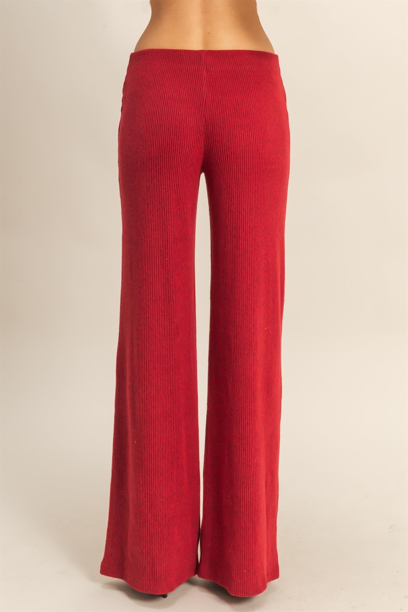 woman wearing high-waisted red ribbed wide-leg pants seen from the back