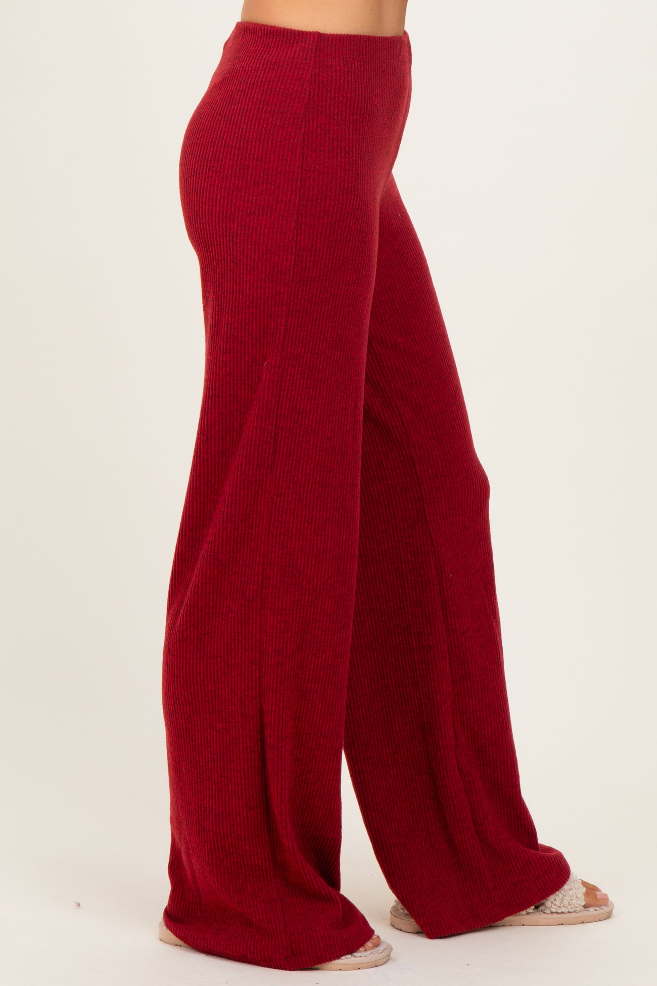women wearing red ribbed wide-leg trousers with a relaxed fit and soft texture