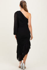 woman wearing a black one-shoulder maternity dress with ruched detailing and a layered ruffle hem
