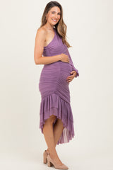 woman wearing a lavender one-shoulder ruched maternity dress with a high-low hemline and cradling her baby bump