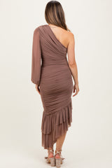 woman wearing a brown one-shoulder maternity dress with ruching and ruffle hem, showing a pregnant baby bump from the back