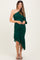 woman wearing a dark green one-shoulder maternity dress with ruched details and ruffle hem, holding her baby bump
