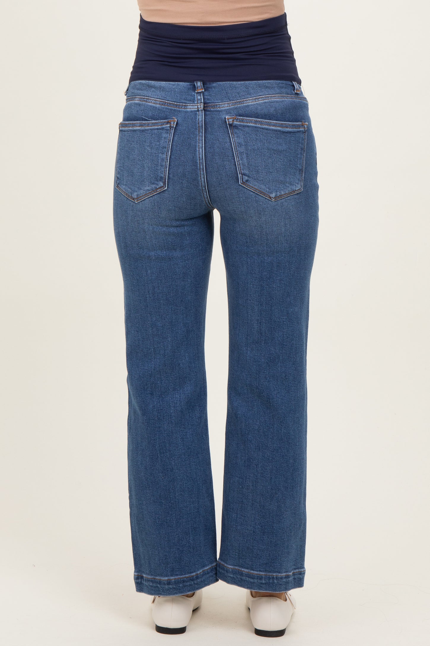 woman wearing dark blue maternity wide-leg jeans, showing an elastic waistband and back pockets