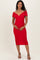 woman wearing a red off-the-shoulder fitted maternity dress and holding her baby bump