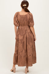 woman wearing a brown floral maxi dress with puff sleeves and a tiered skirt, viewed from the back