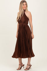 woman wearing a brown pleated midi dress with a halter neckline and a tie waist detail