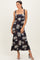 woman wearing a navy floral maxi dress with square neckline and wide straps
