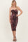 woman wearing a burgundy strapless bodycon dress with ruched detailing and a sweetheart neckline