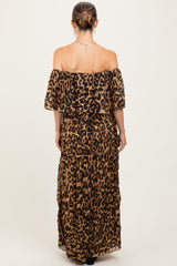 woman wearing a leopard print off-the-shoulder maternity maxi dress, showcasing a flowy fit from the back