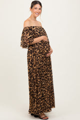 woman wearing a leopard print off-the-shoulder maternity maxi dress and holding her baby bump