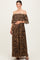 woman wearing a brown leopard print off-shoulder maternity maxi dress and holding her baby bump