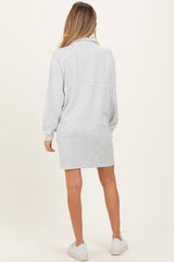 woman wearing a gray maternity sweatshirt dress with long sleeves, showing the back view