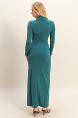 woman wearing a teal long sleeve maxi dress with a fitted silhouette, shown from the back
